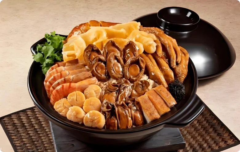 客家盆菜：鲍鱼、海参、花菇、烧肉、鱿鱼、炸腐皮一层层码满一盆，底下素、上头荤
